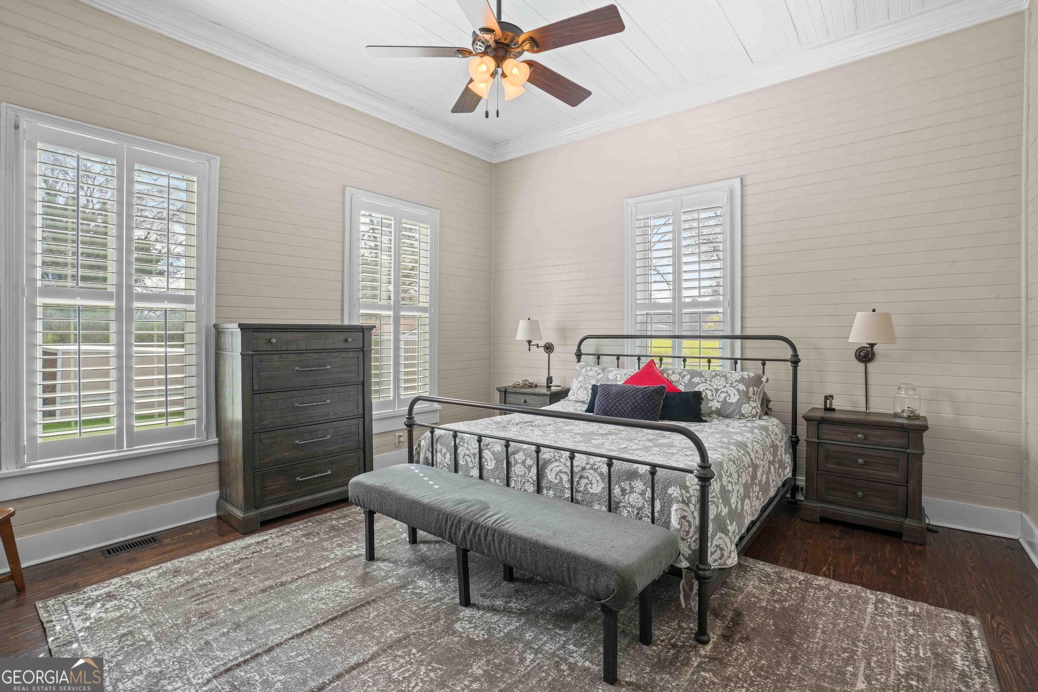 193 Bartee Road Woodbury, GA 30293 - Photo 40 of 84 a bedroom with a bed a dresser and wooden floor