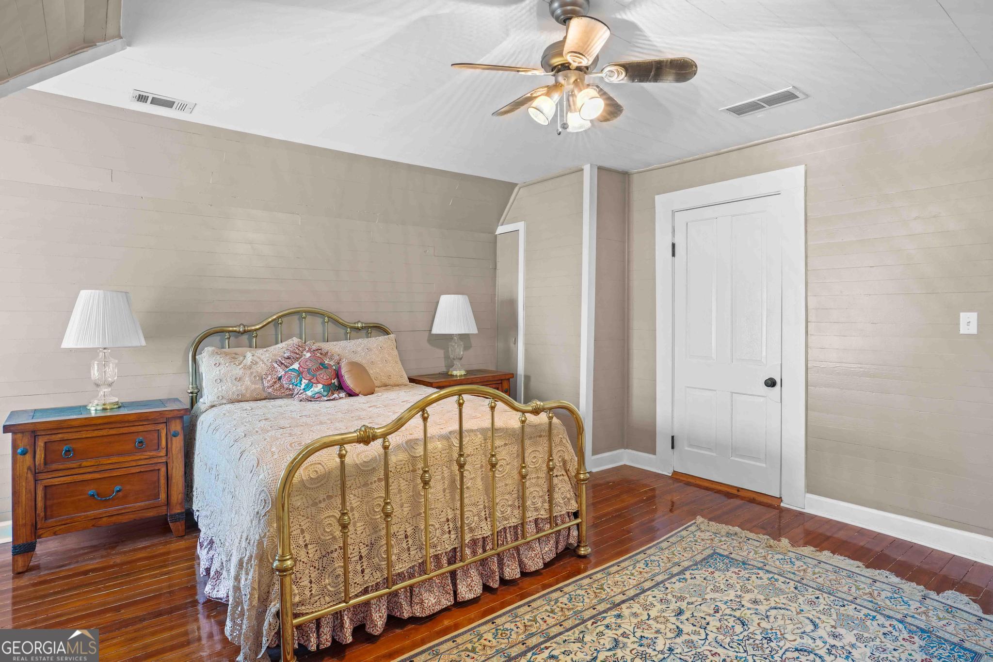 193 Bartee Road Woodbury, GA 30293 - Photo 56 of 84 a bedroom with a bed and wooden floor