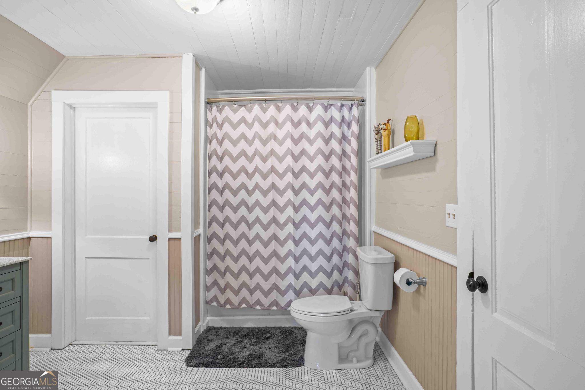 193 Bartee Road Woodbury, GA 30293 - Photo 57 of 84 a white toilet sitting next to a shower curtain