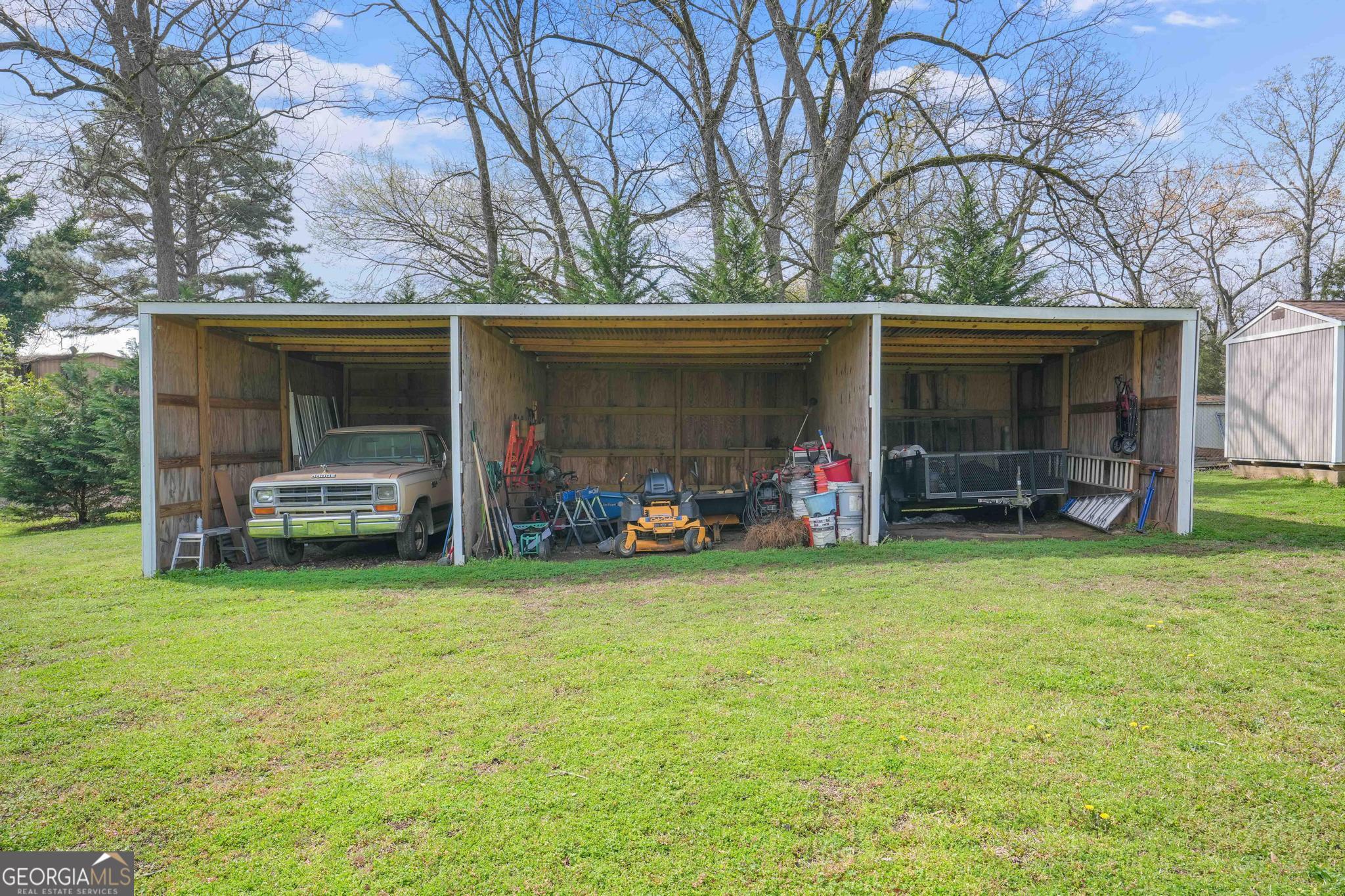 193 Bartee Road Woodbury, GA 30293 - Photo 68 of 84 a view of a backyard with table and chairs and a large tree