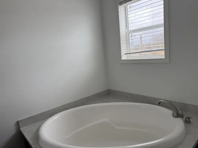 a white bath tub sitting in a bathroom