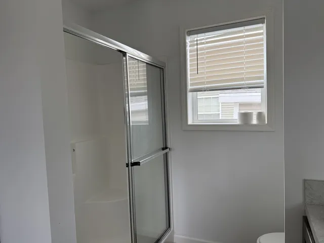 a bathroom with a shower and a window