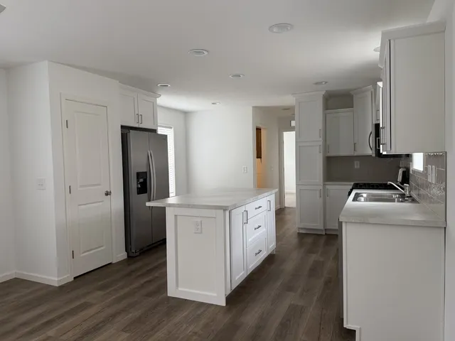 a kitchen with white cabinets and white appliances