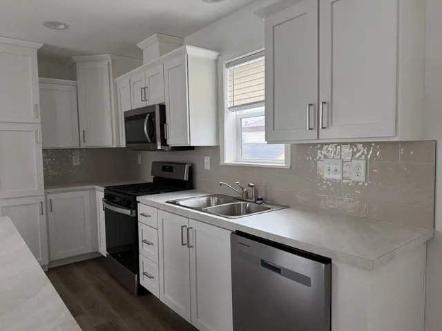 a kitchen with a sink stove and cabinets