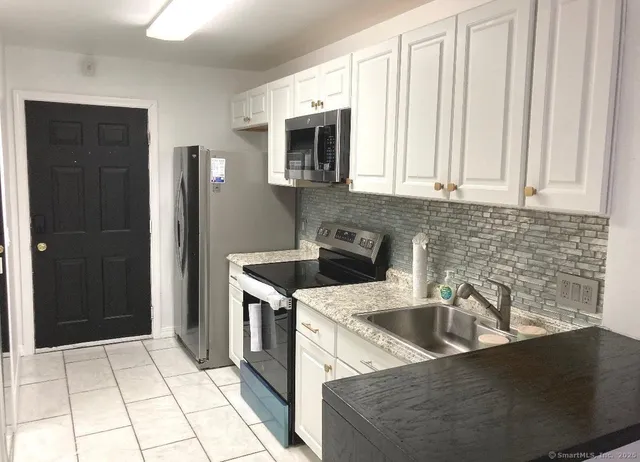 a kitchen that has a sink and a stove