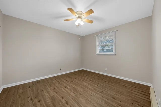 wooden floor in an empty room with a window