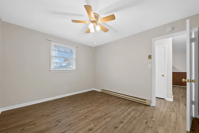 wooden floor in an empty room with a window
