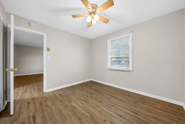 a view of a grassy field with trees