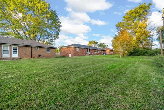 a view of a backyard with entertaining space