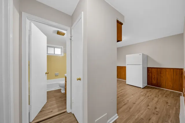 a kitchen with wooden floors and white appliances