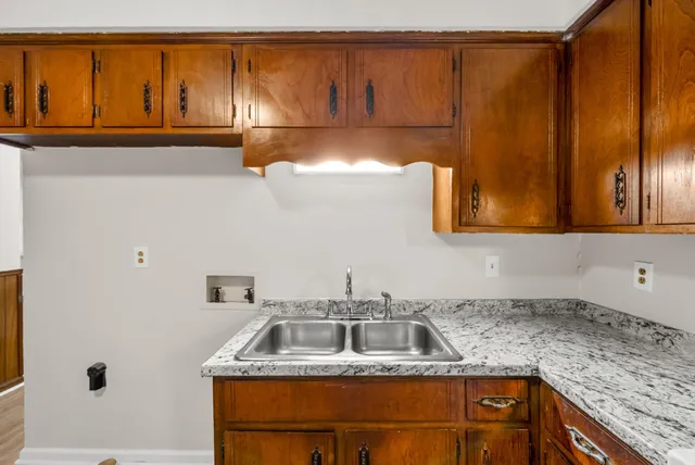 a kitchen with a cabinets and wooden floor