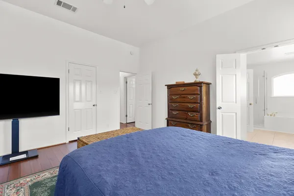 a bedroom with a bed and a flat screen tv