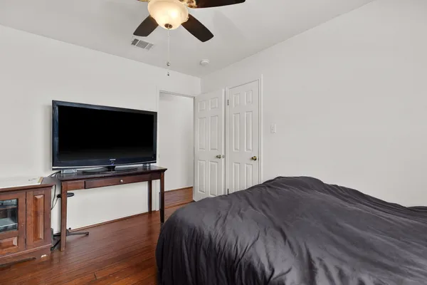 a bedroom with a bed and a flat screen tv