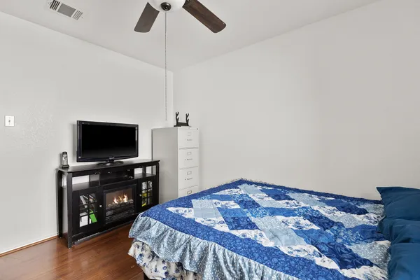 a bedroom with a bed and a television