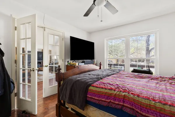 a bedroom with a bed and a flat screen tv