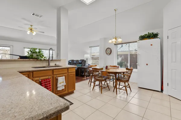 a kitchen with stainless steel appliances granite countertop sink stove top oven and cabinets