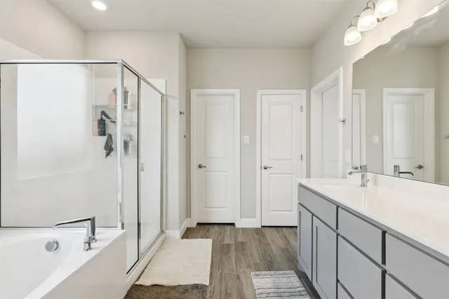 a bathroom with a sink a mirror and a bathtub