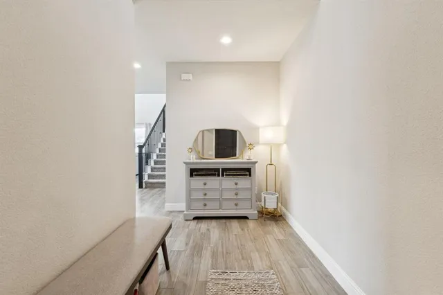 a view of a bedroom with wooden floor