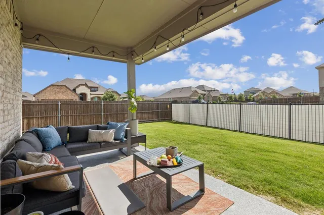 a view of swimming pool with a couches chairs and a yard