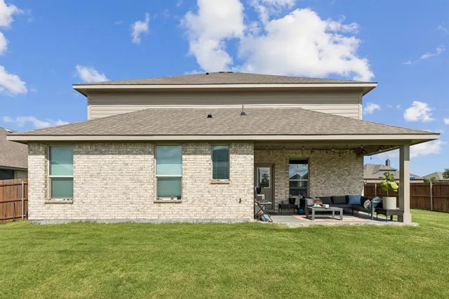 a view of a house with backyard and sitting area