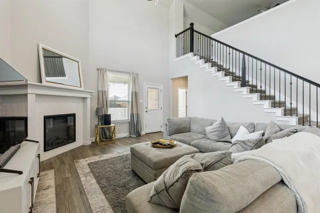 a living room with furniture fireplace and a rug