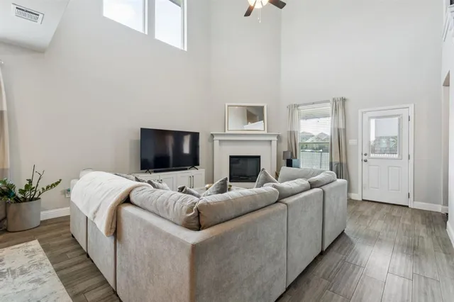 a living room with furniture fireplace and flat screen tv