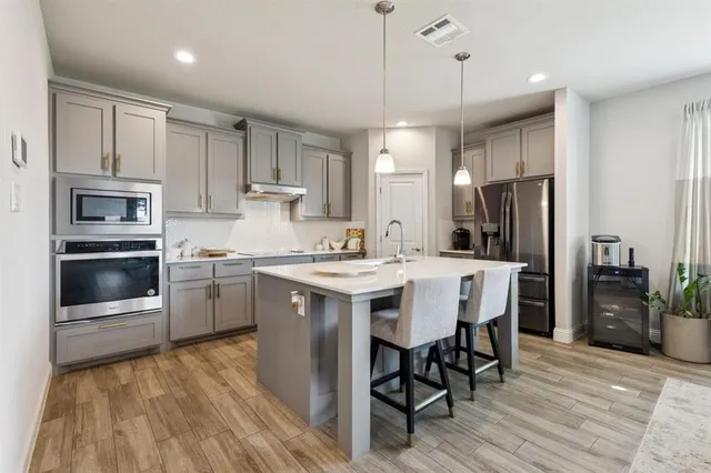 a kitchen with a sink stainless steel appliances and cabinets