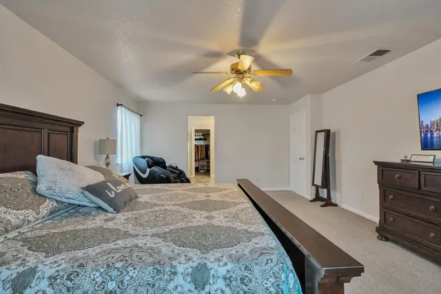 a bedroom with a bed and a chair