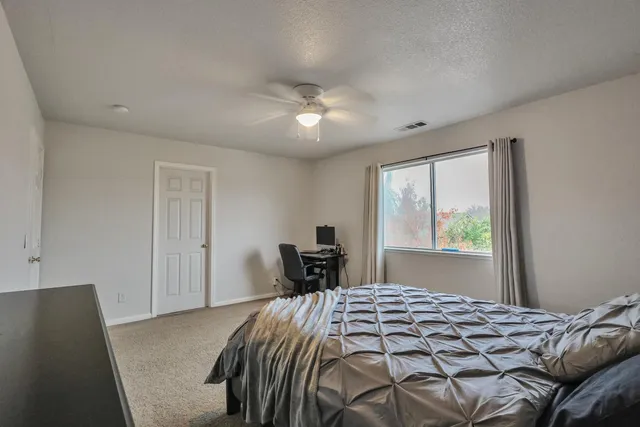 a view of a house with swimming pool and sitting area