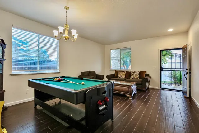 a view of a livingroom with furniture fire place and wooden floor