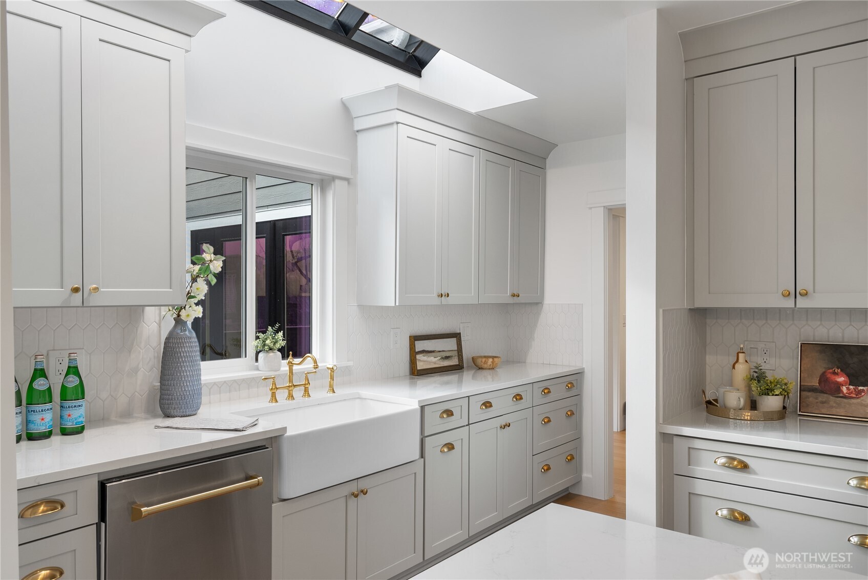 1014 4th Avenue North Seattle, WA 98109 - Photo 13 of 40 a kitchen with cabinets appliances a sink and a window