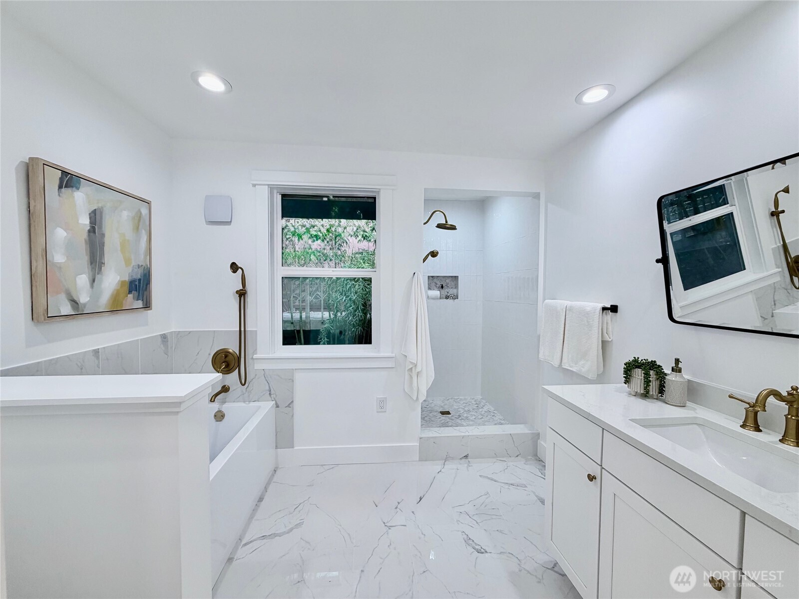 1014 4th Avenue North Seattle, WA 98109 - Photo 23 of 40 a spacious bathroom with a tub sink and mirror