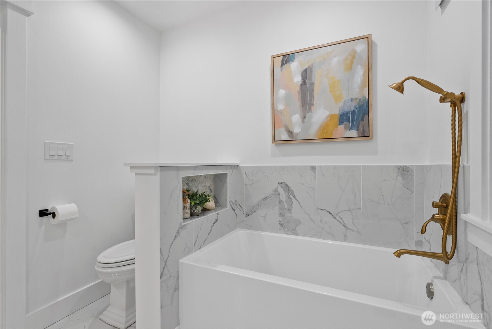 1014 4th Avenue North Seattle, WA 98109 - Photo 24 of 40 a white bath tub sitting next to a white toilet and a shower