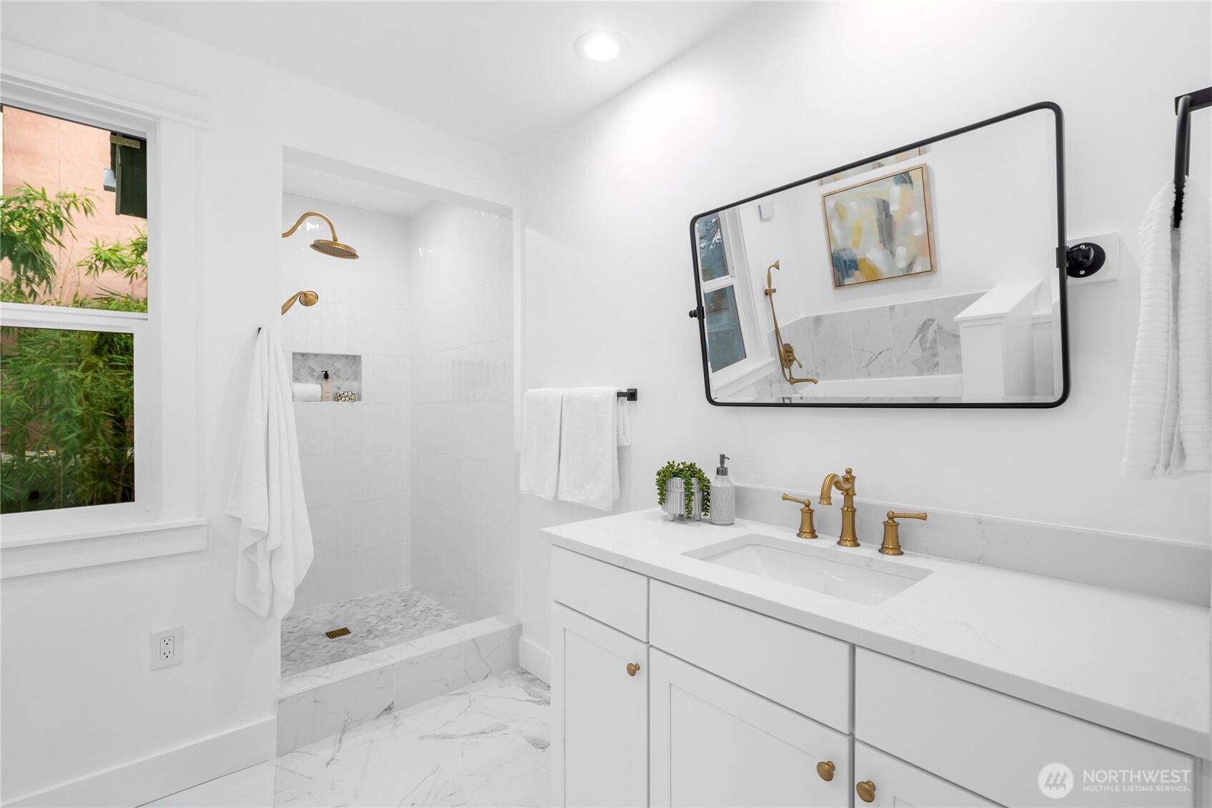 1014 4th Avenue North Seattle, WA 98109 - Photo 25 of 40 a bathroom with a shower sink and mirror