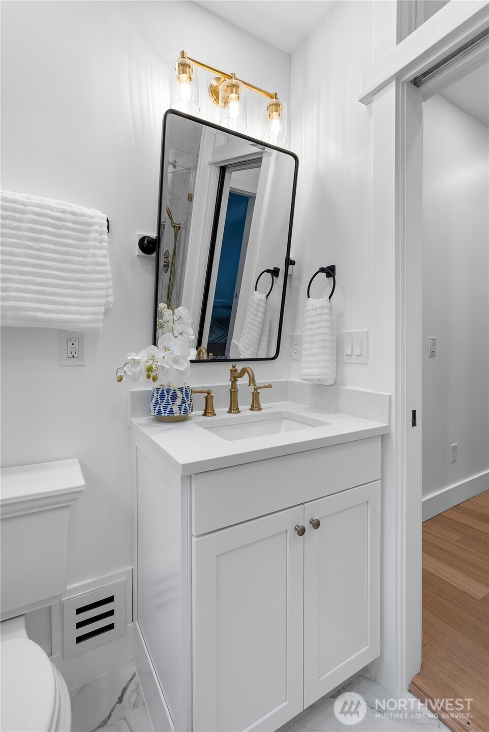 1014 4th Avenue North Seattle, WA 98109 - Photo 29 of 40 a bathroom with a sink vanity mirror and toilet