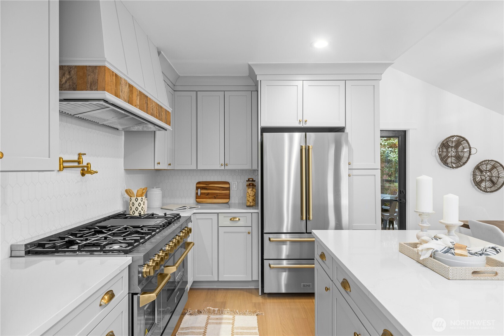 1014 4th Avenue North Seattle, WA 98109 - Photo 9 of 40 a kitchen with a sink a refrigerator and cabinets