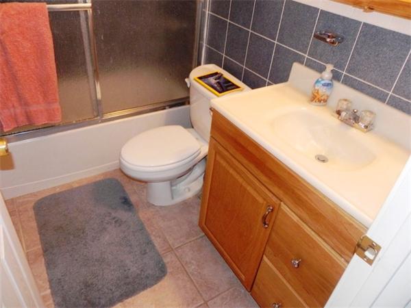 130 8 Briarcliff Road, Unit 1 Raynham, MA 02767 - Photo 13 of 13 a bathroom with a toilet and a sink