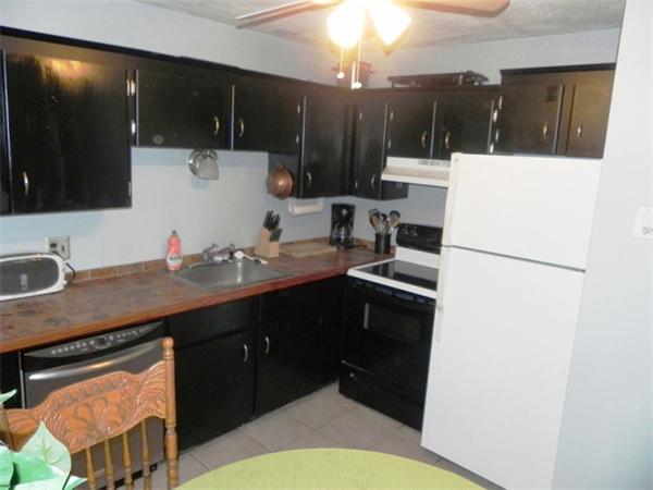 130 8 Briarcliff Road, Unit 1 Raynham, MA 02767 - Photo 4 of 13 a kitchen with a sink a stove a refrigerator and cabinets