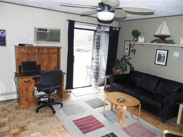 130 8 Briarcliff Road, Unit 1 Raynham, MA 02767 - Photo 5 of 13 a living room with furniture and a chandelier