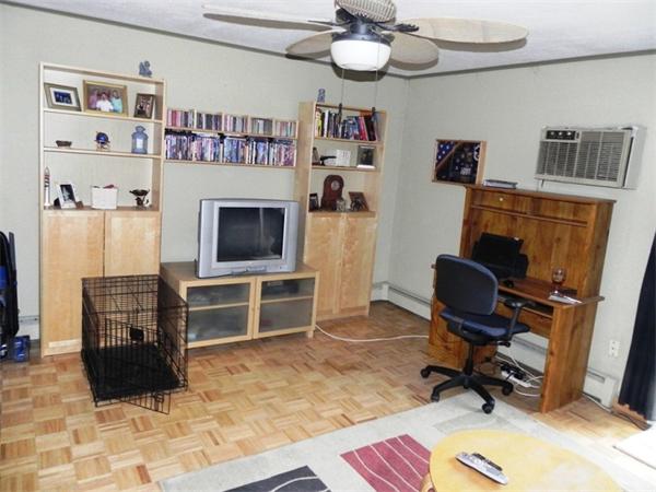 130 8 Briarcliff Road, Unit 1 Raynham, MA 02767 - Photo 6 of 13 a view of a workspace with furniture and a flat screen tv