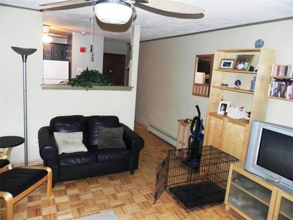 130 8 Briarcliff Road, Unit 1 Raynham, MA 02767 - Photo 7 of 13 a living room with furniture and a flat screen tv