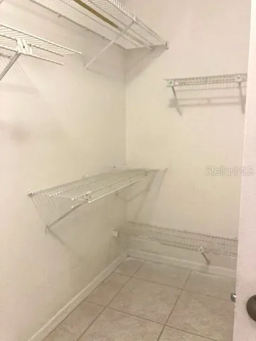 a view of an empty room with window and an empty room