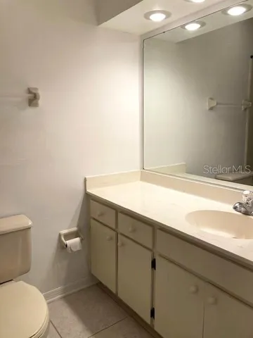 a white refrigerator freezer and a stove sitting inside of a kitchen