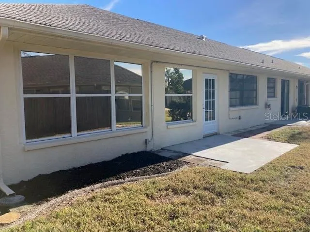 a view of a field with trees in background