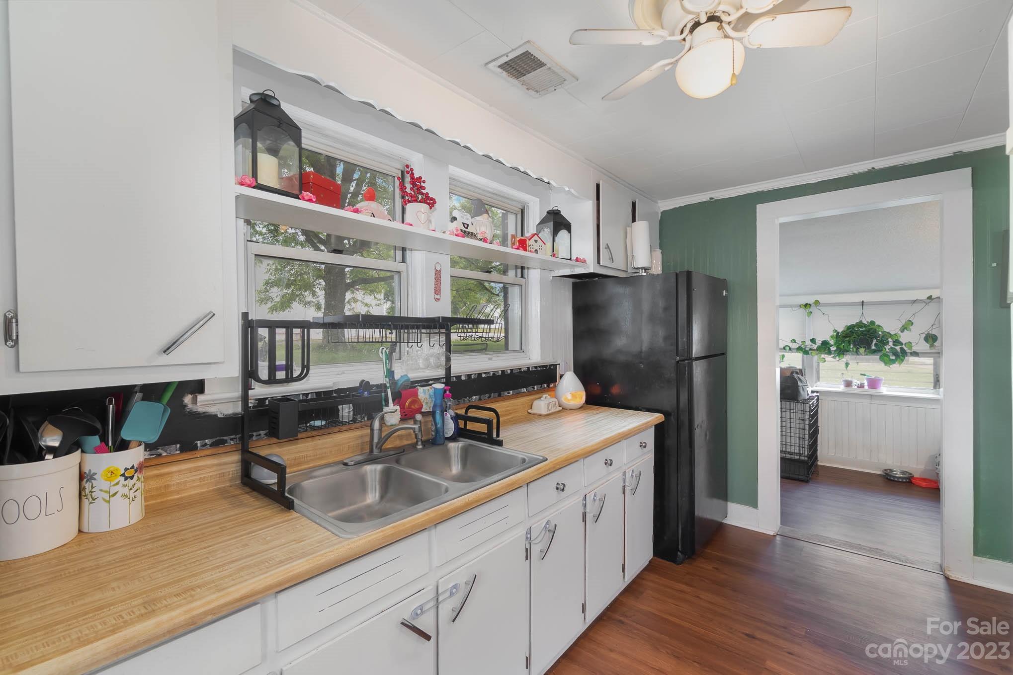 19 Union Street Maiden, NC 28650 - Photo 14 of 29 a kitchen with stainless steel appliances granite countertop a sink dishwasher and a refrigerator with wooden floor