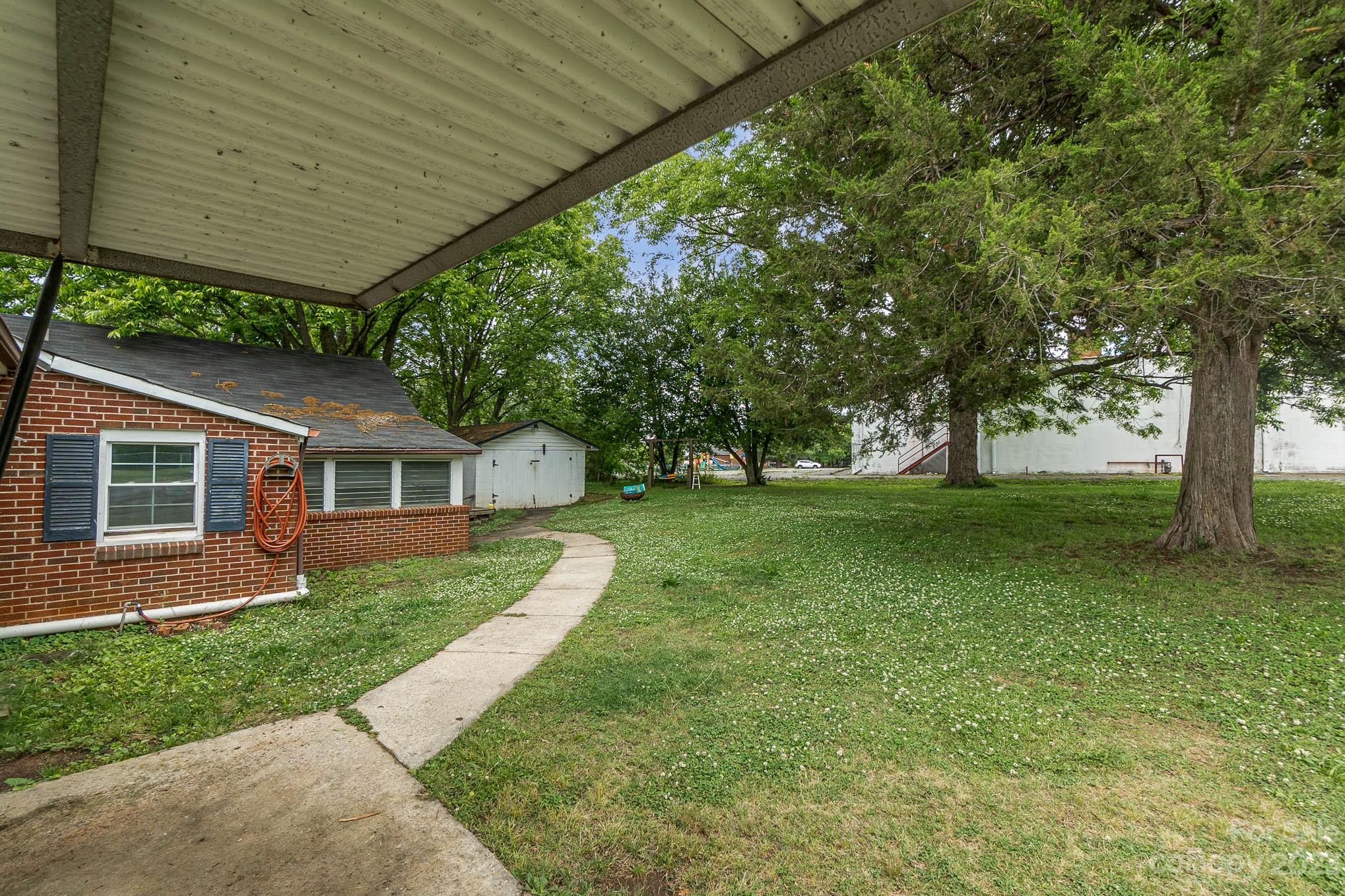 19 Union Street Maiden, NC 28650 - Photo 25 of 29 a view of a house next to a big yard and large trees