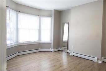 344 Bushkill Street, Unit 2 Easton, PA 18042 - Photo 7 of 30 A spacious sun-filled room with elegant wood flooring and a charming bay window.