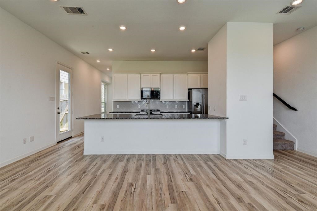 4115 Balboa Drive Iowa Colony, TX 77583 - Photo 3 of 9 a view of kitchen with stainless steel appliances granite countertop a stove a sink and a refrigerator