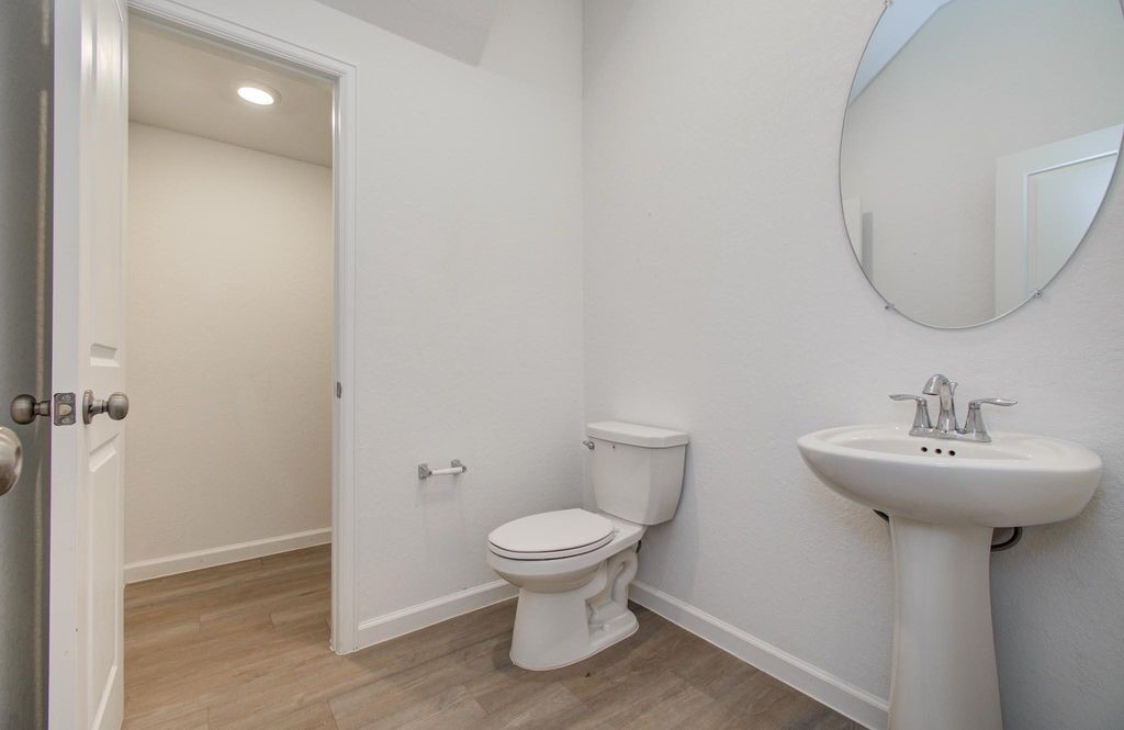 4115 Balboa Drive Iowa Colony, TX 77583 - Photo 4 of 9 a bathroom with a sink toilet and a mirror
