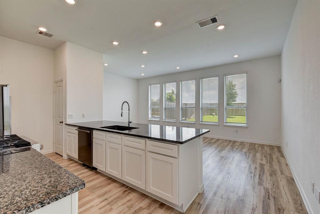 4115 Balboa Drive Iowa Colony, TX 77583 - Photo 7 of 9 a kitchen with granite countertop a sink and a stove top oven